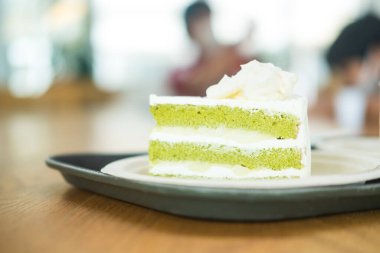 Sliced green tea mix with coconut cake. Close up