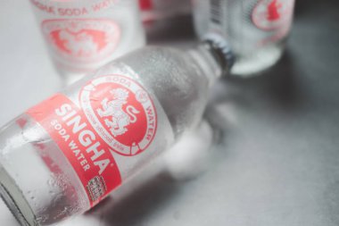 Samut Prakan, Thailand - August 6, 2022 : New logo bottle of Singha Corporation brand soda is a fizzy beverage made from compressed water with carbon dioxide gas, created by Singha corporation company