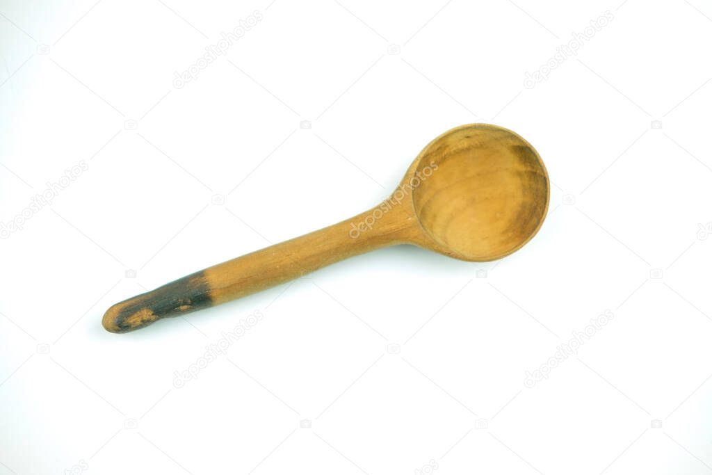 Old wooden spoon on a white background. Top view