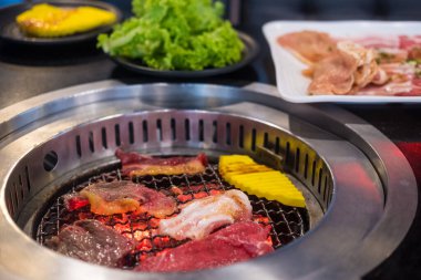 Japanese style grilled meat or barbecue on steel wire mesh, yakiniku is traditional grilled meat cuisine with various kind of slice beef and pork.