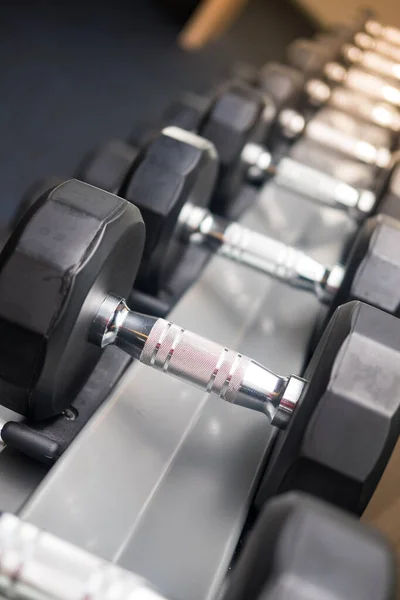 Dumbbells on rack in the gym for bulking and weight building to get a bigger body, fitness routines.