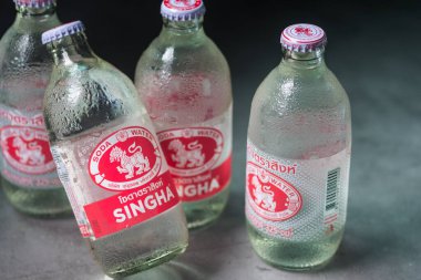 Samut Prakan, Thailand - August 12, 2022 : Singha Corporation brand soda is a fizzy beverage has been infused with carbon dioxide gas under pressure. New logo and old logo on bottle