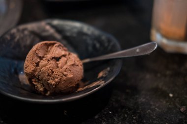 Chocolate ice cream ball in a bowl. Close up