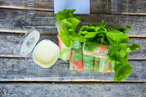 Salad Rolls Packed Transparent Box Salad Dressing Wood Table — Zdjęcie stockowe