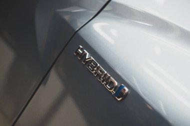 Samut Prakan, Thailand - August 20, 2022 : Close up of hybrid logo, Hybrid cars can use both electricity and petrol. The car brand Toyota uses this logo for its hybrid cars.