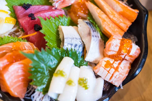 Fresh sashimi, raw fish mixed in traditional Japanese style a colorfully decorated large plate