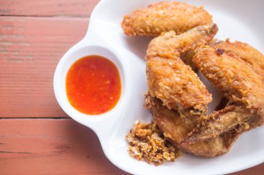 Thai style homemade deep fried chicken wings eating with rice and you can dipping sweet sauce