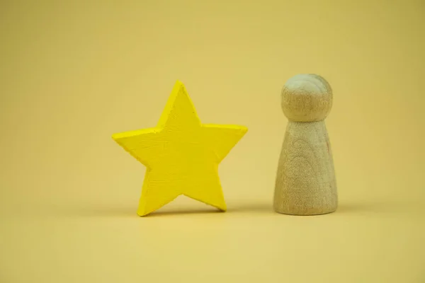 wooden figures peg doll standing 1st positions with wooden cube blocks star. ranking and strategy concept.