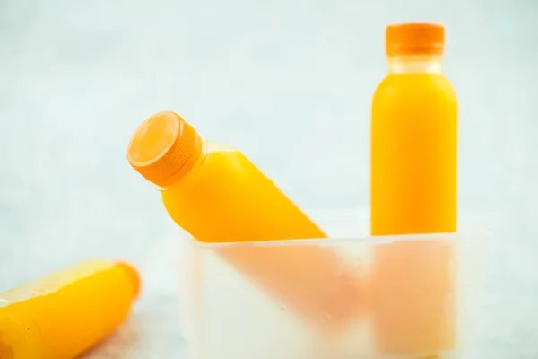Fresh orange juice in no label clear plastic bottle with orange cap