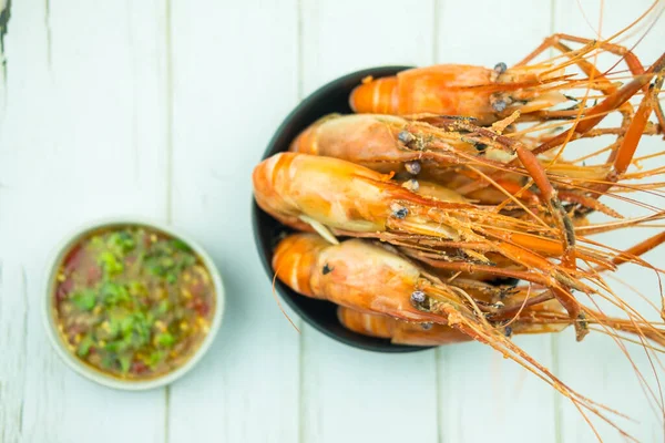 Seafood a boiled river prawns its big shrimps common in a black bowl. Top view