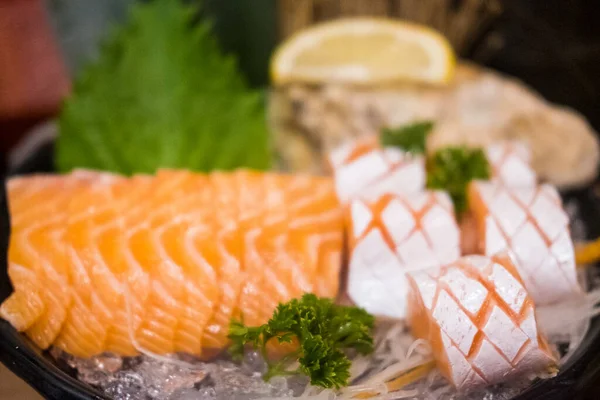 Raw salmon slice or salmon sashimi in Japanese style fresh serve on ice in bowl. Japanese traditional food or with low calories and high nutrition.