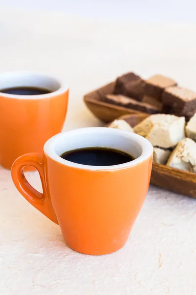 Two modern coffee cups with plates of sweets — Stock Photo, Image