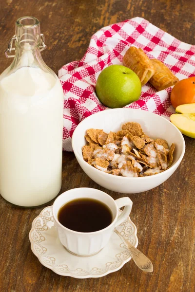 Healthy breakfast with granola, fruits, nuts and milk.