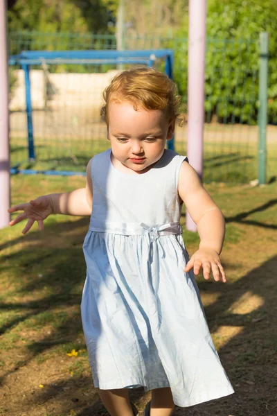 Cute little girl running on playgraund — Stock Photo, Image