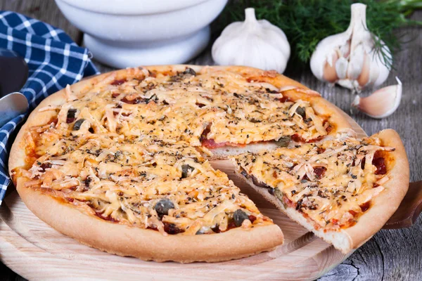 Кусок пиццы с сыром на деревянной доске — стоковое фото