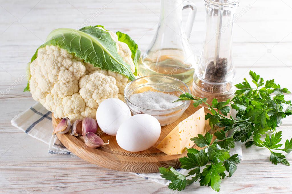 Ingredients for cooking cauliflower with egg and cheese with herbs and spices