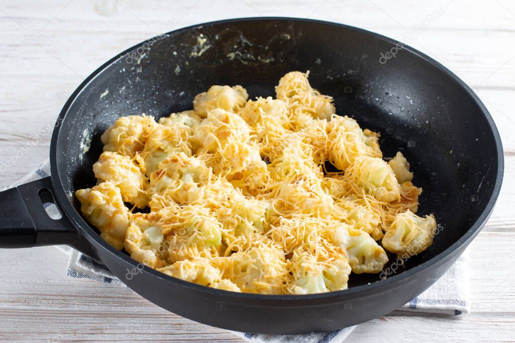 Fried cauliflower with egg and cheese with herbs and spices