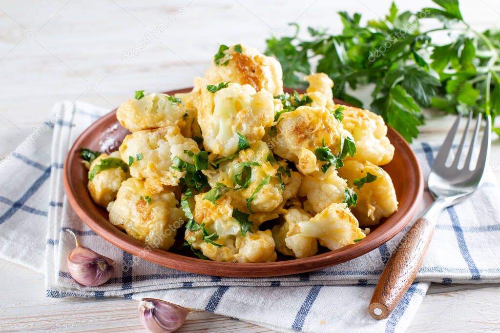 Fried cauliflower with egg and cheese with herbs and spices