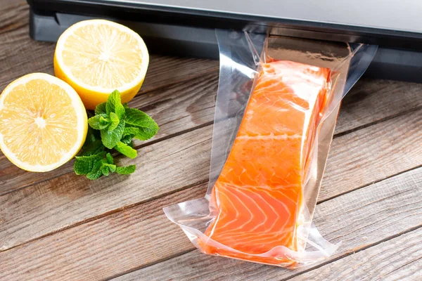 Vacuum seal packing machine for keep all food longer life. Salmon fillets in a vacuum package