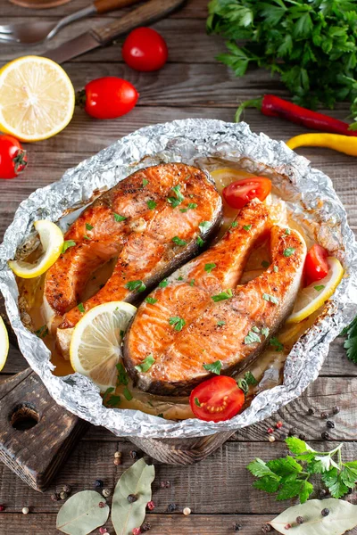 Foil pack dinner with fish. Fillet of salmon. Healthy diet food, keto diet, Mediterranean cuisine. Oven-baked hot dinner, close up