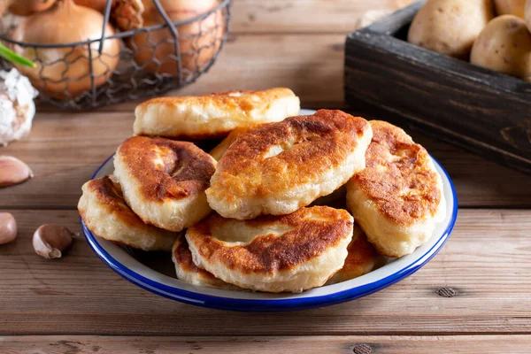 Traditional Russian pies with potatoes. Russian pirozhki, homemade patties.