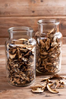 Dried mushrooms. Mushrooms in jar on the old wooden table