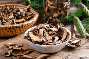Arrangement of Forest Dried Mushrooms on Rustic Wooden table. Focus on Foreground