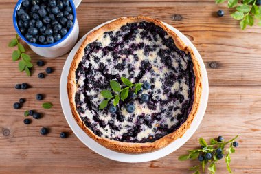 Traditional homemade blueberry pie on rustic wooden table, top view