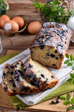Blueberry cake with fresh berries on rustic wooden table. Selective focus.