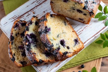 Home baked cake with blueberries on rustic wooden table