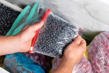 Packages with frozen blueberry in the freezer. Frozen food, frozen berries