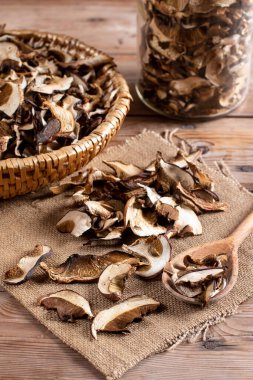 Arrangement of Forest Dried Mushrooms on Rustic Wooden table. Focus on Foreground