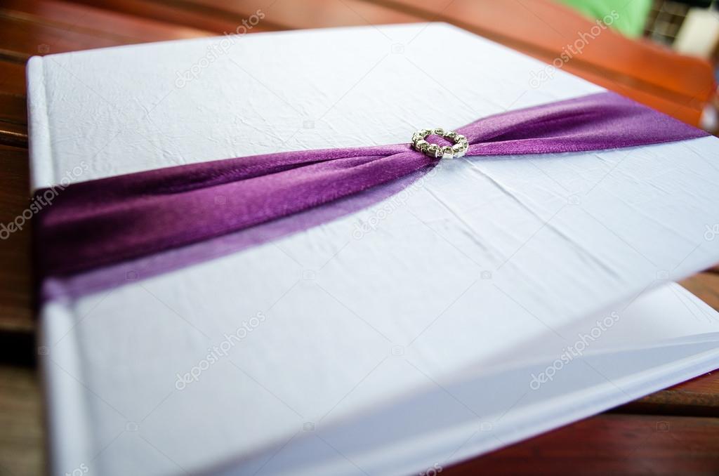 Wedding decoration guest book with purple ribbon