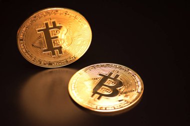 Bitcoin on a black background with reflection