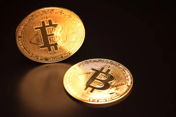 Bitcoin on a black background with reflection