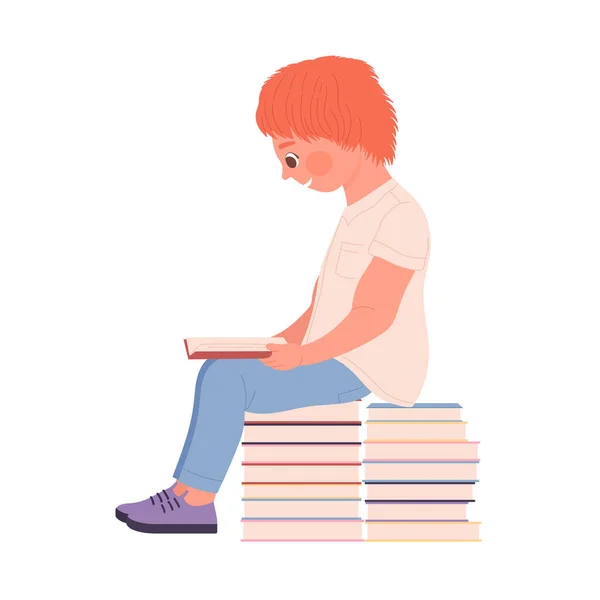 Симпатичный рыжеволосый мальчик сидит на куче книг и читает — стоковый вектор