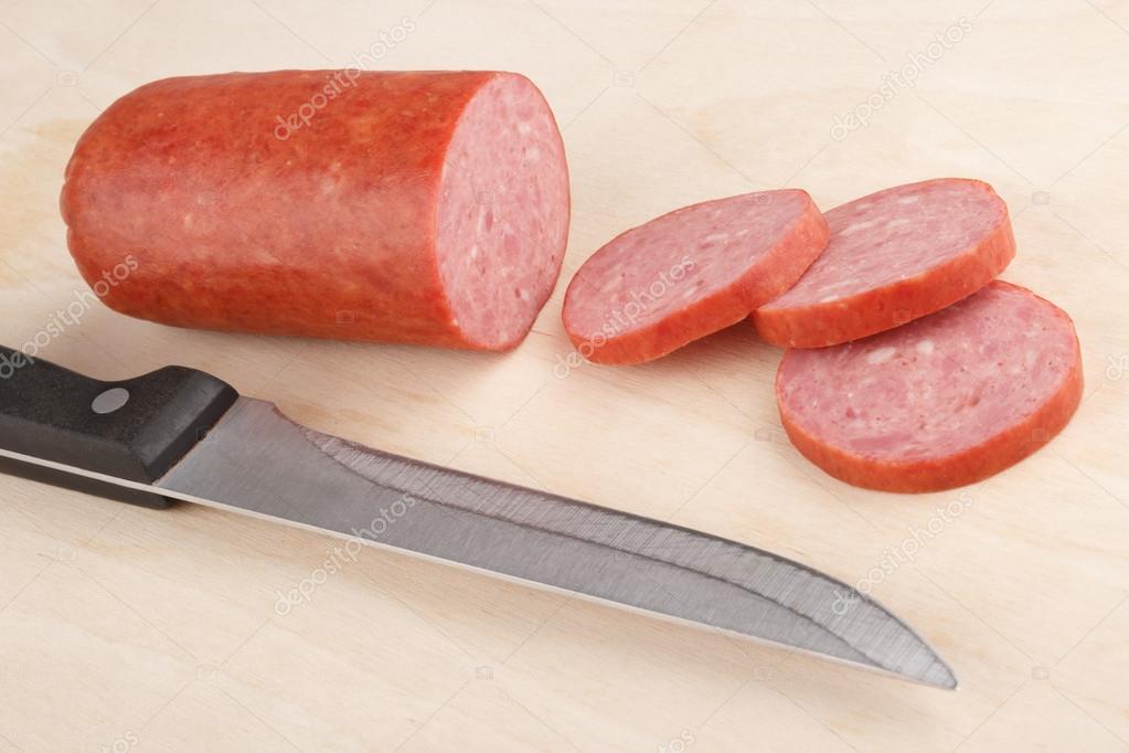 Cutting sausage — Stock Photo © DP 35176437
