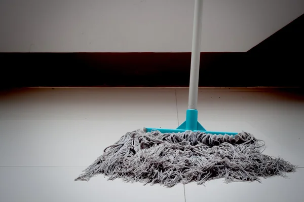 Dirty mop on white floor — Stock Photo, Image