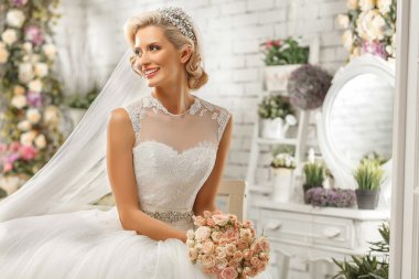 The beautiful  woman posing in a wedding dress