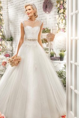 The beautiful  woman posing in a wedding dress