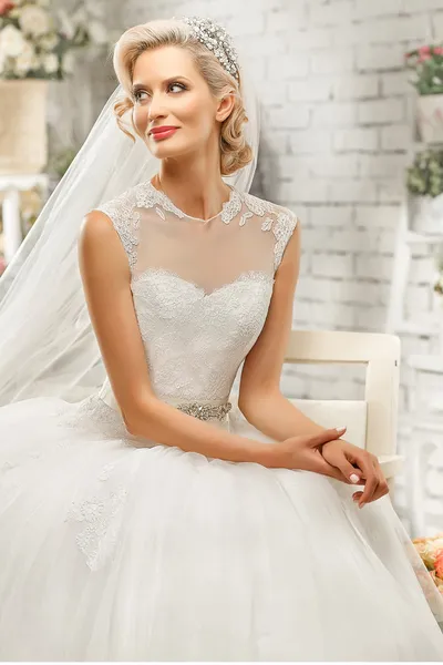 The beautiful  woman posing in a wedding dress