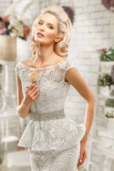 The beautiful  woman posing in a wedding dress