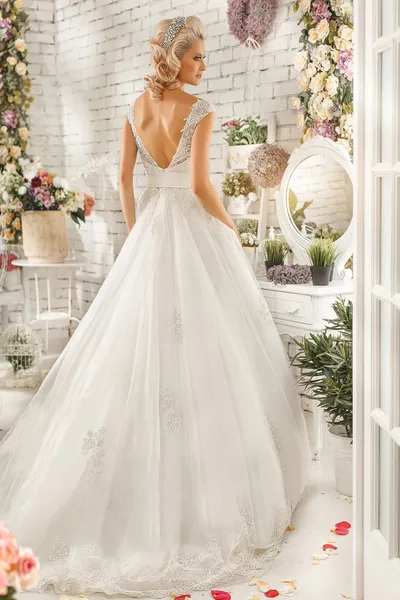 The beautiful  woman posing in a wedding dress