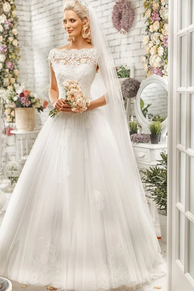 The beautiful  woman posing in a wedding dress