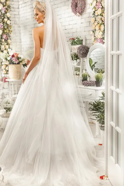 The beautiful  woman posing in a wedding dress