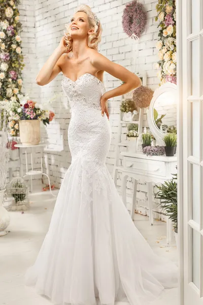 Die schöne Frau posiert im Hochzeitskleid — Stockfoto