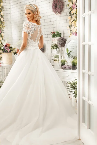 The beautiful  woman posing in a wedding dress