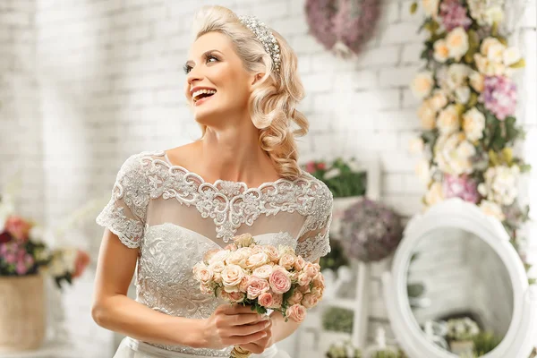 The beautiful  woman posing in a wedding dress — Stok fotoğraf