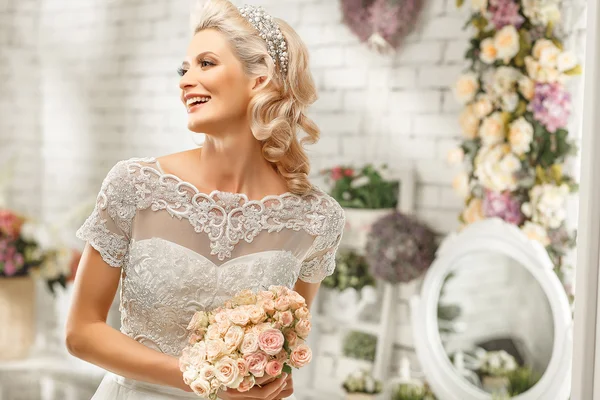 The beautiful  woman posing in a wedding dress — Stock Photo, Image