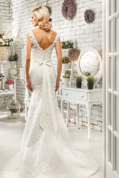 The beautiful  woman posing in a wedding dress